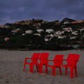 Czerwone krzesła, które stały sobie o poranku na plaży